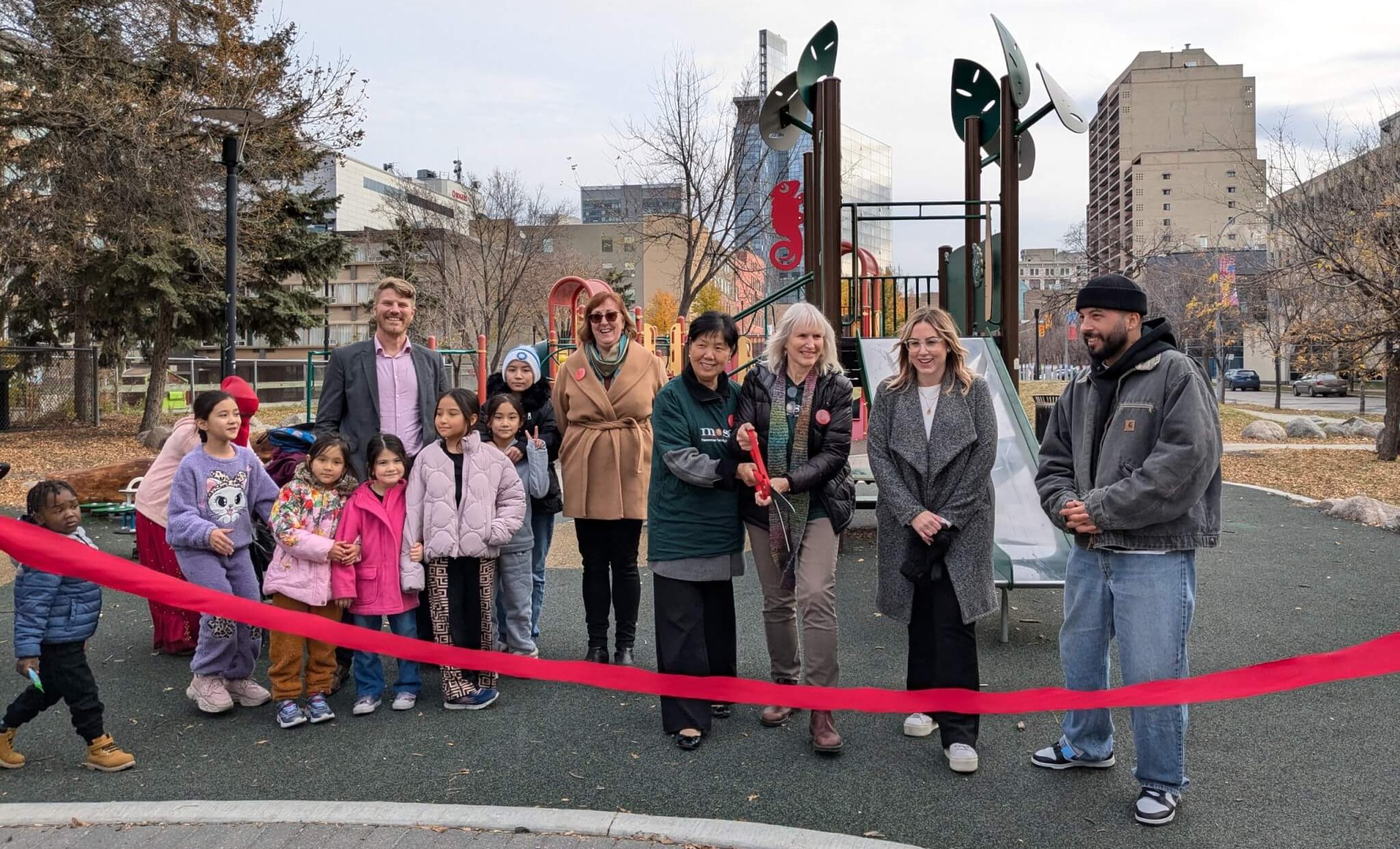Val and others are ready to cut the ribbon during the opening of children's playground