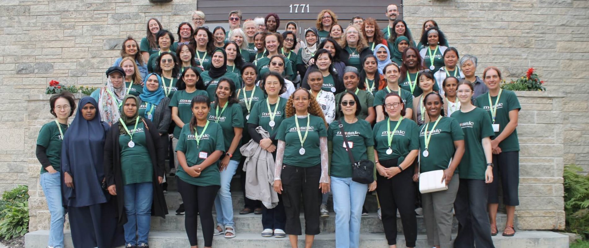 Mosaic all staff picture, united team in Mosaic shirts happily smiling