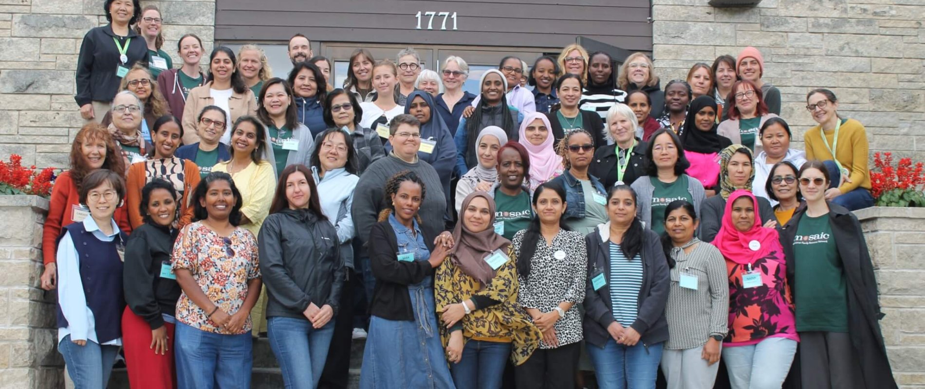 Photo of all Mosaic staff members happily standing together.