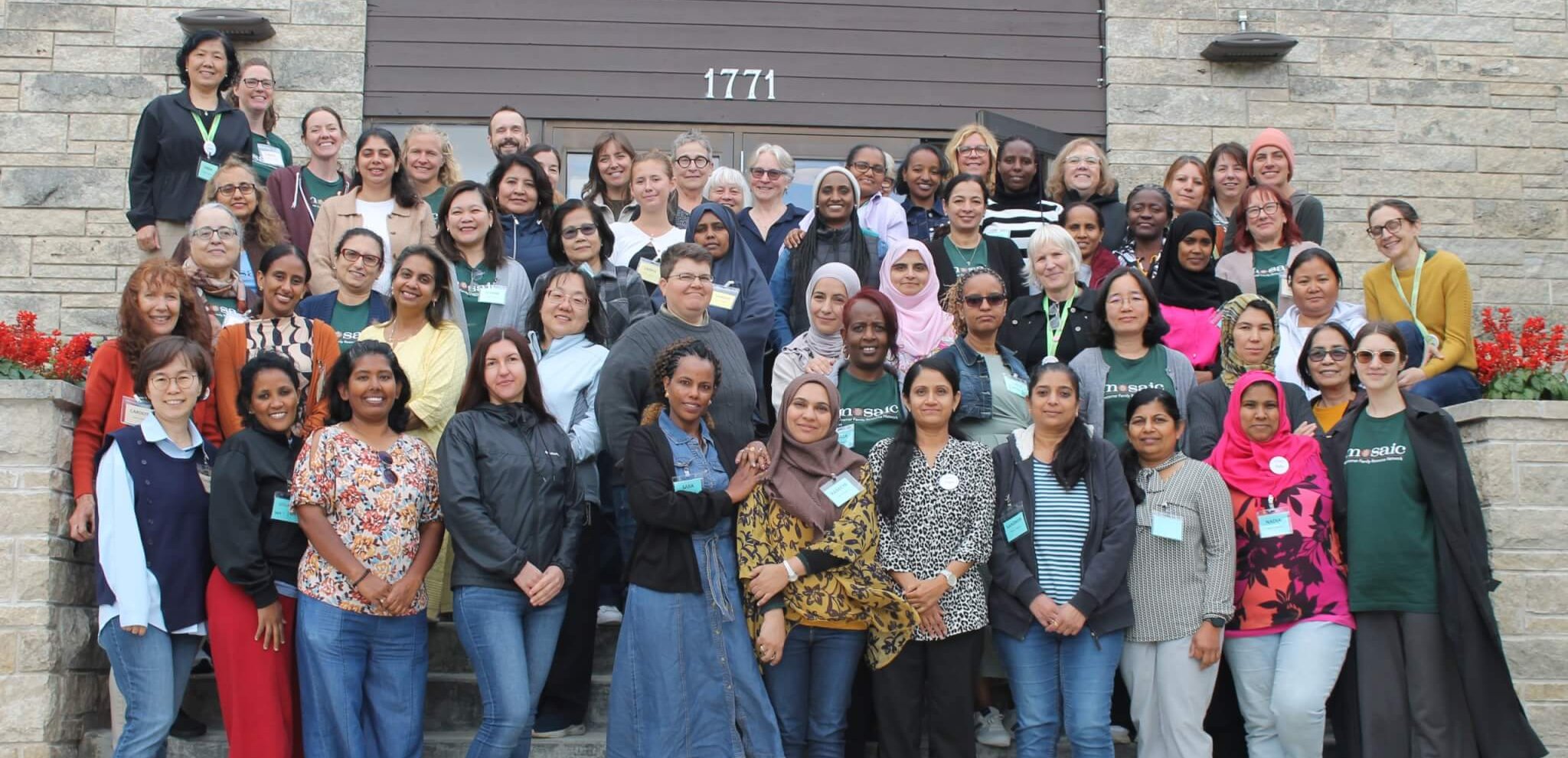 Photo of all Mosaic staff members happily standing together.